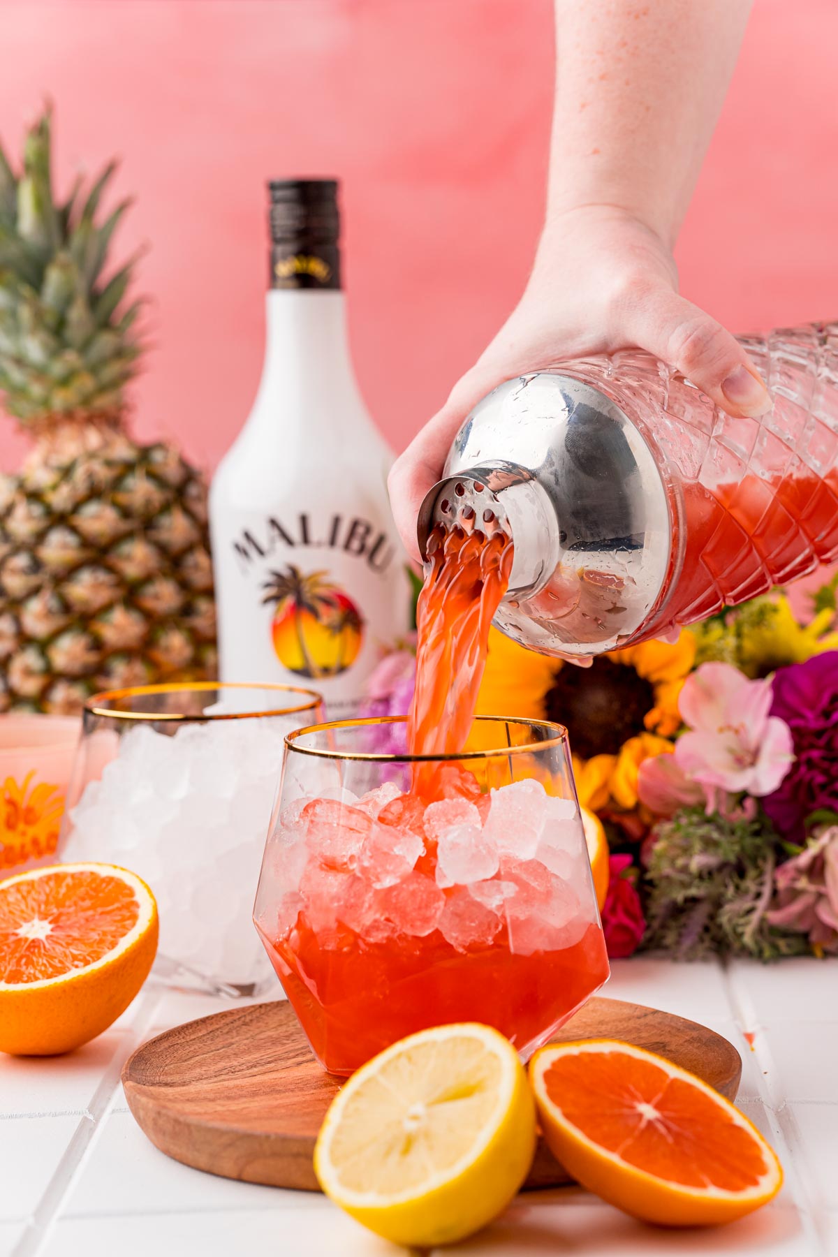 A bahama mama cocktail being strained into a glass.