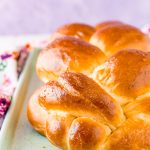 Close up photo of a loaf of Challah bread on a baking sheet.