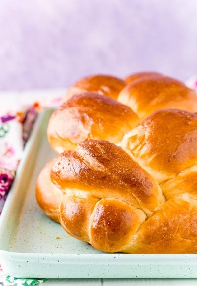 Close up photo of a loaf of Challah bread on a baking sheet.