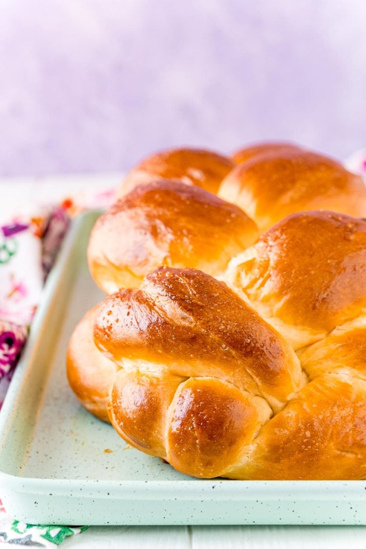 Close up photo of a loaf of Challah bread on a baking sheet.