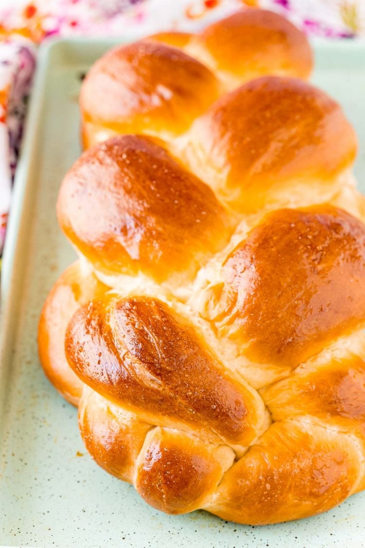 Close up photo of a loaf of Challah bread on a baking sheet.