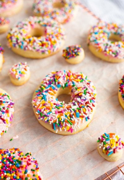 These Donut Cookies are soft, lightly sweetened cookies that are covered in easy-to-make icing and then topped with fun colorful sprinkles!