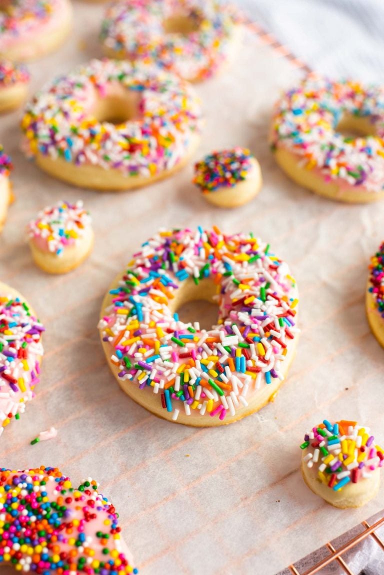 These Donut Cookies are soft, lightly sweetened cookies that are covered in easy-to-make icing and then topped with fun colorful sprinkles!