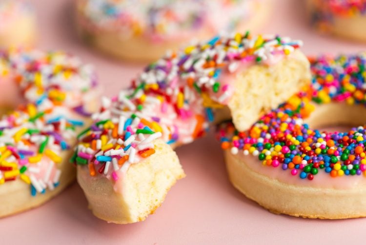 Close up photo of donut cookies with a bite taken out of it.