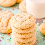 Stack of funfetti cake mix cookies on a blue surface.