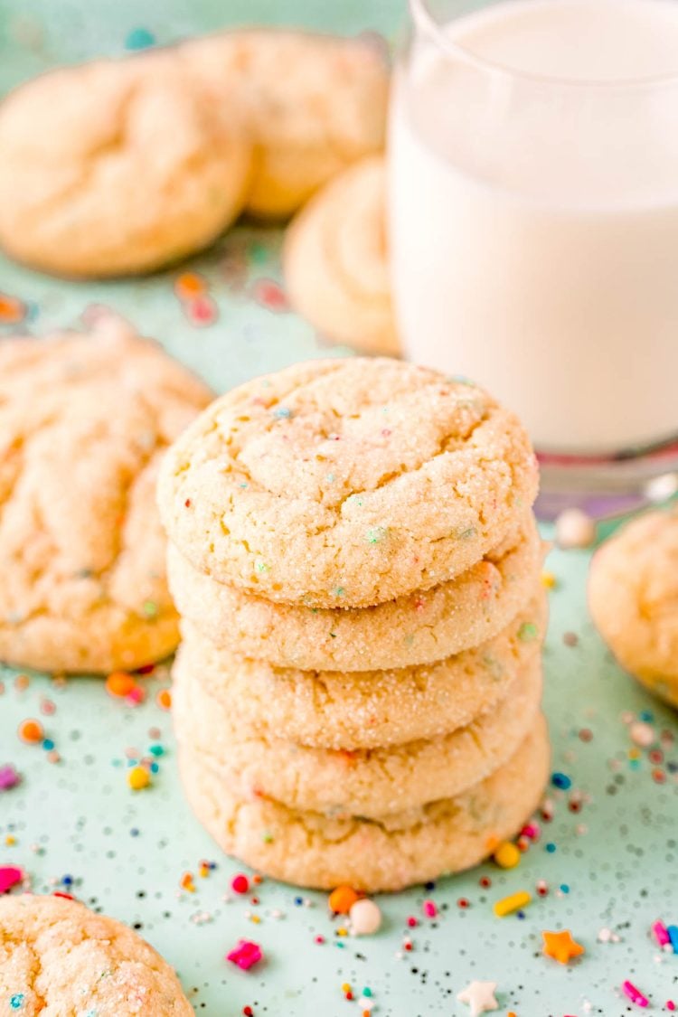 Stack of funfetti cake mix cookies on a blue surface.