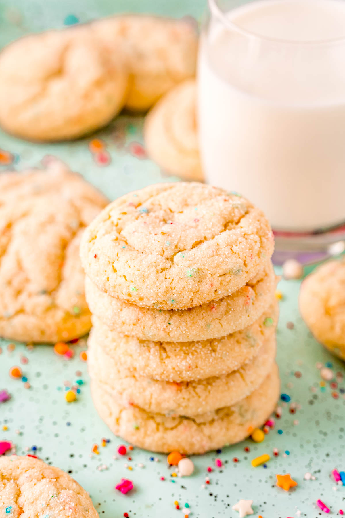 Stack of funfetti cake mix cookies on a blue surface.