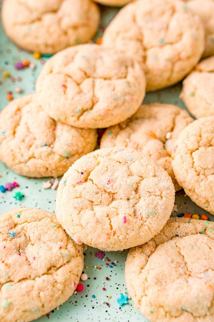 Funfetti cake mix cookies on a blue baking sheet.