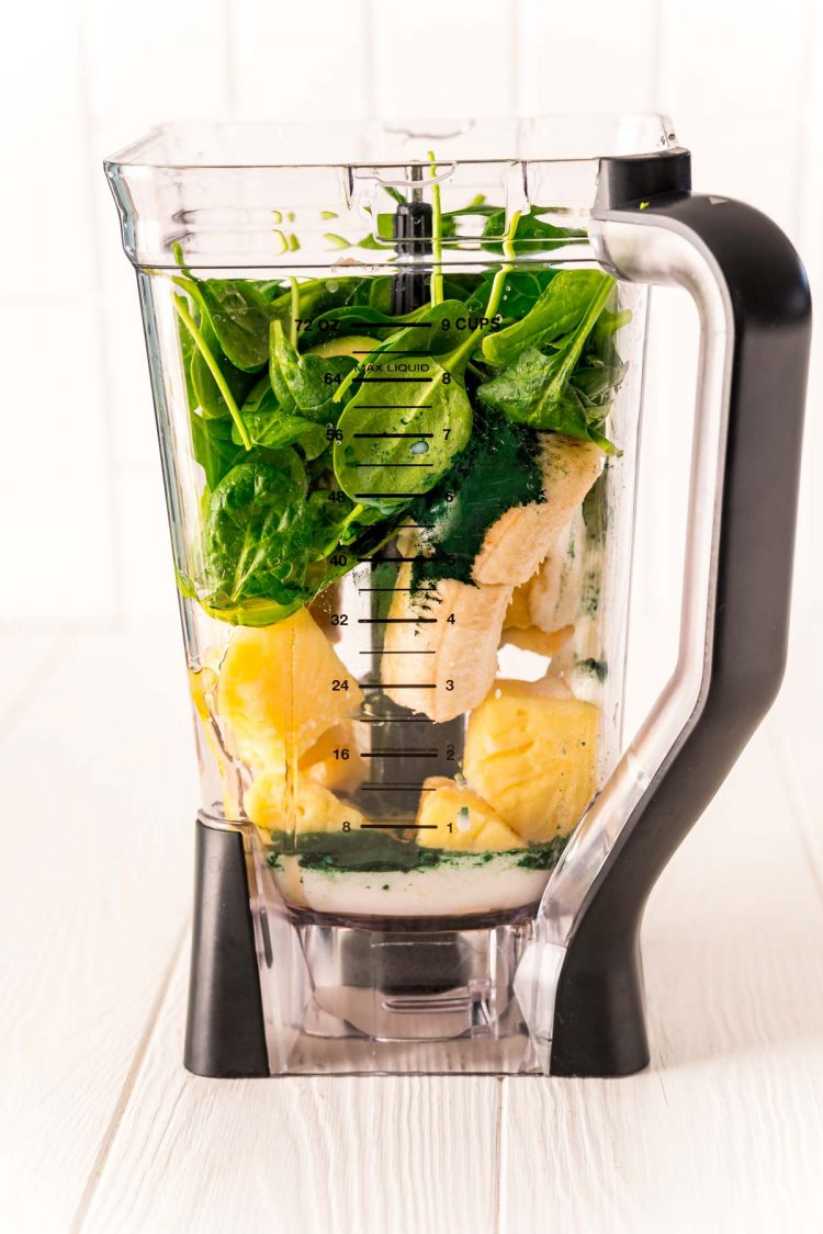 Ingredients to make a green smoothie in a blender.