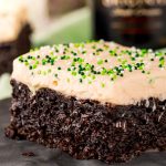 Close up photo of chocolate irish cream cake on a black plate.