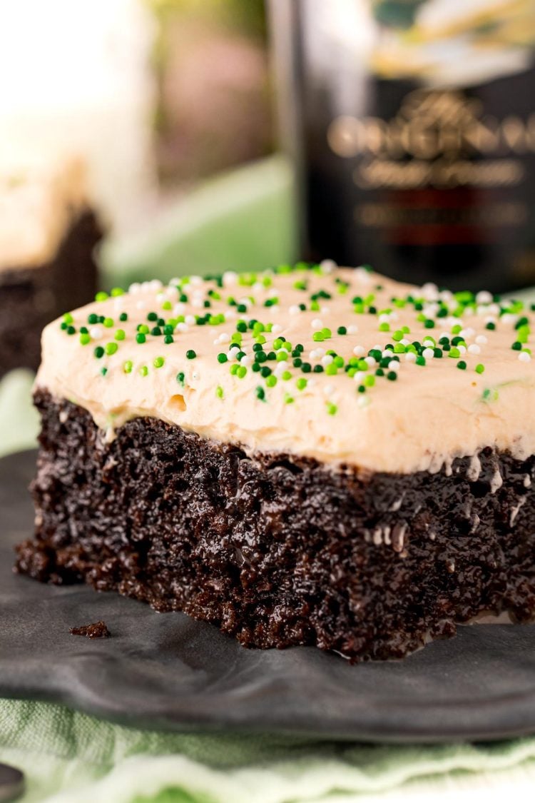 Close up photo of a slice of chocolate cake with irish cream frosting.