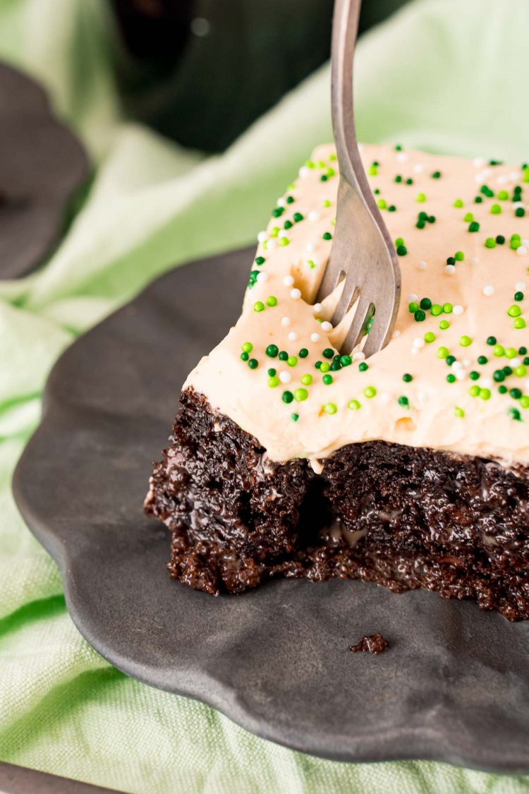 Close up photo of a fork taking a bite out of Bailey's cake.