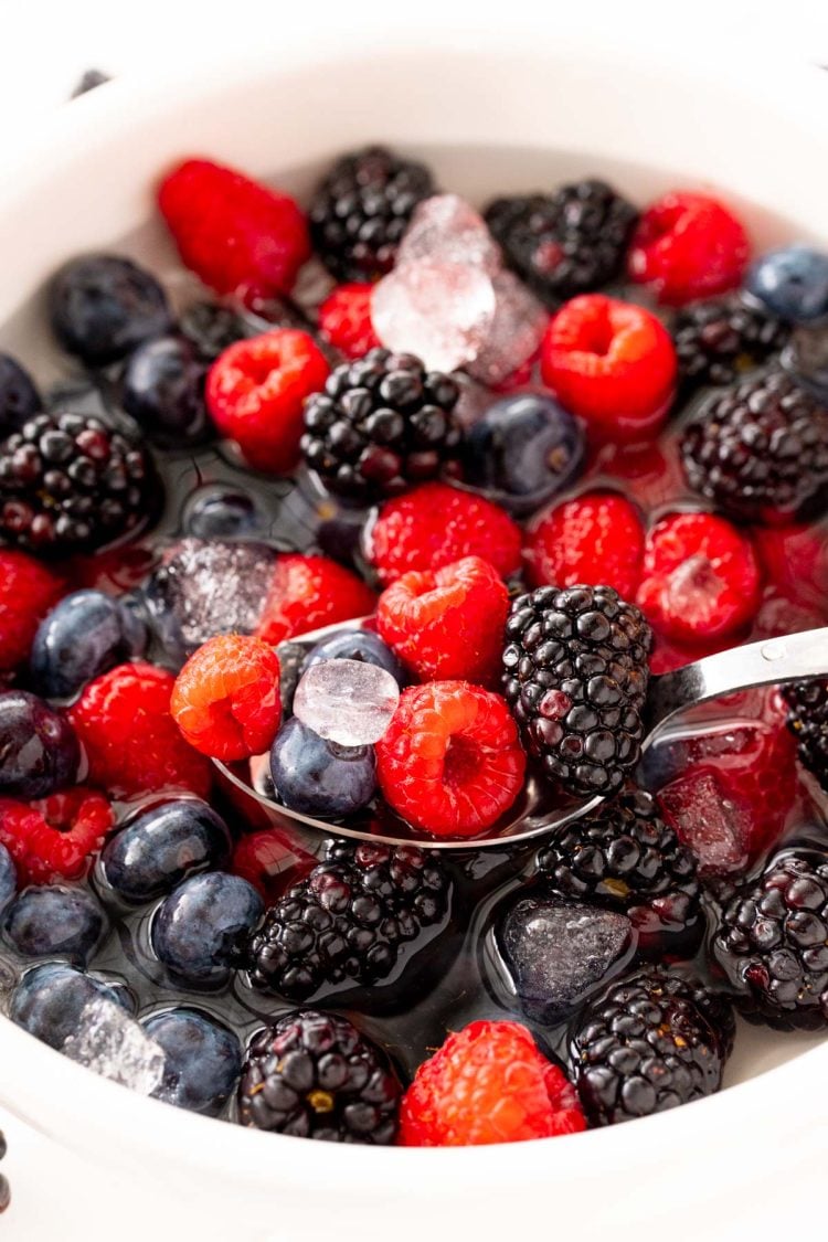 Close up photo of nature's cereal made with berries in a white bowl.