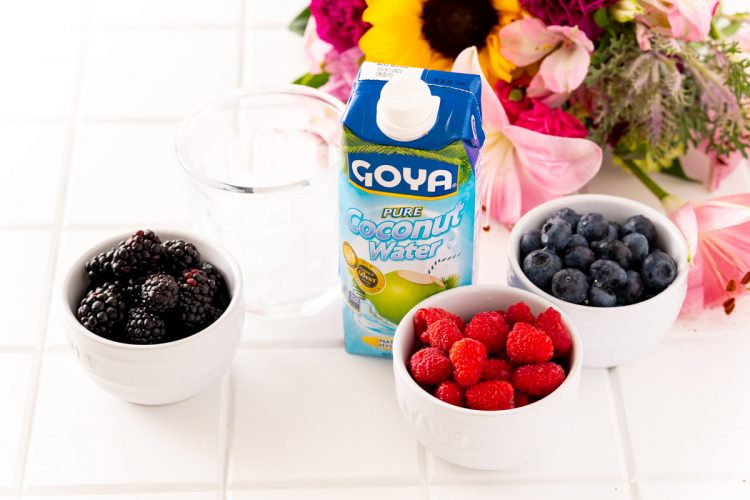 Ingredients to make Nature's Cereal on a white table with flowers in the background.