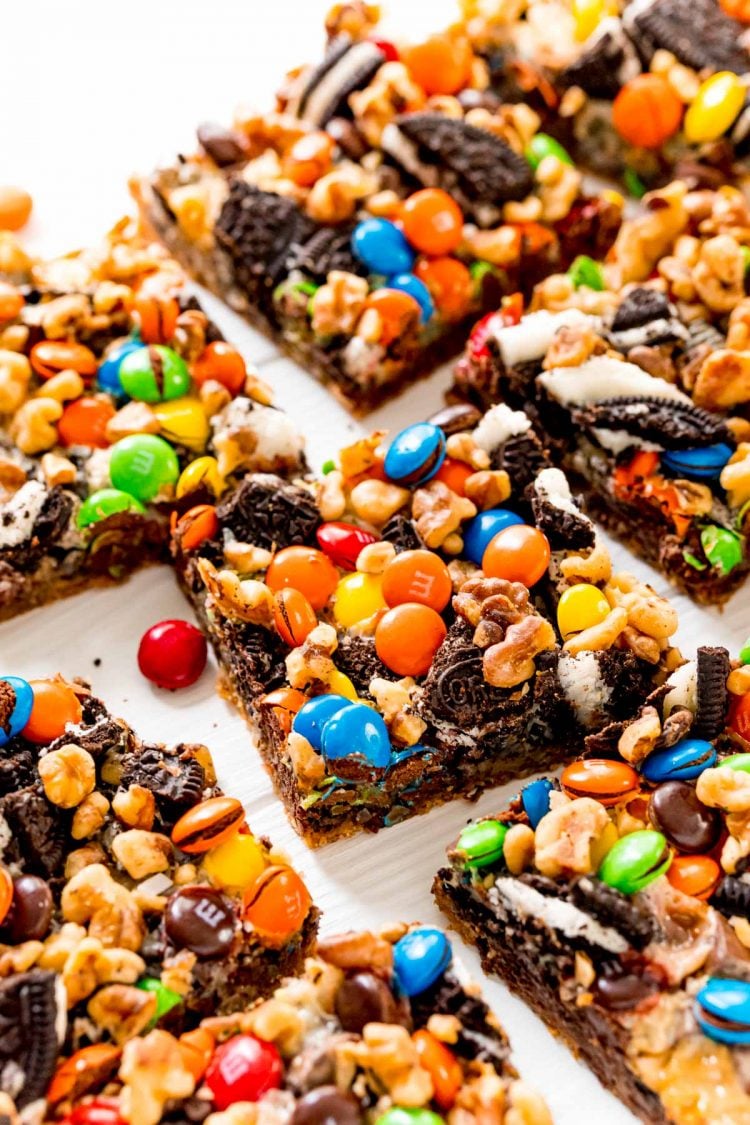 Close up photo of M&M 7 Layer Bars on a white table.