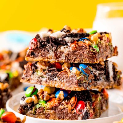 Close up photo of a stack of three oreo cookie bars on a white plate.