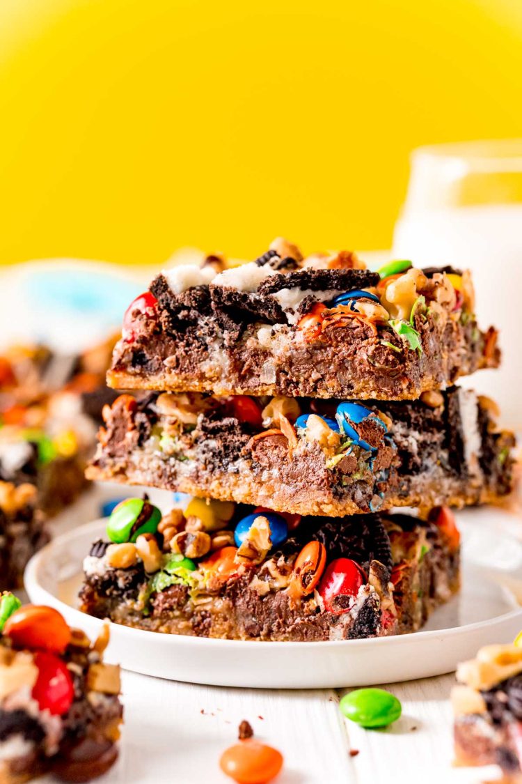 Close up photo of a stack of three oreo cookie bars on a white plate.