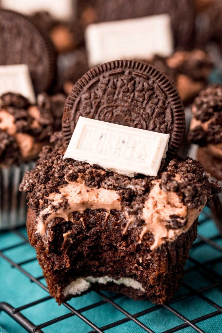 Close up photo of an Oreo Cupcake with a bite taken out of it.