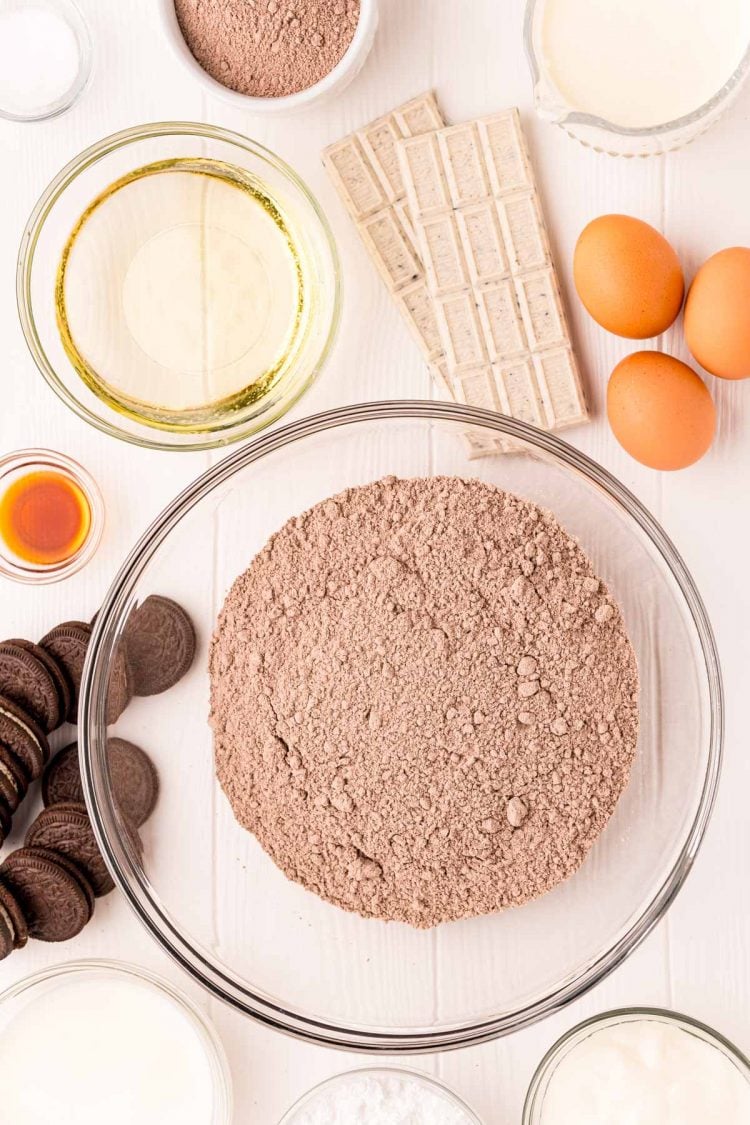 Ingredients to make oreo Cupcakes on a white table.