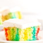 This Rainbow Jello Poke Cake is easily made using a boxed white cake mix and jello to create a fun, light dessert filled with vibrant colors!