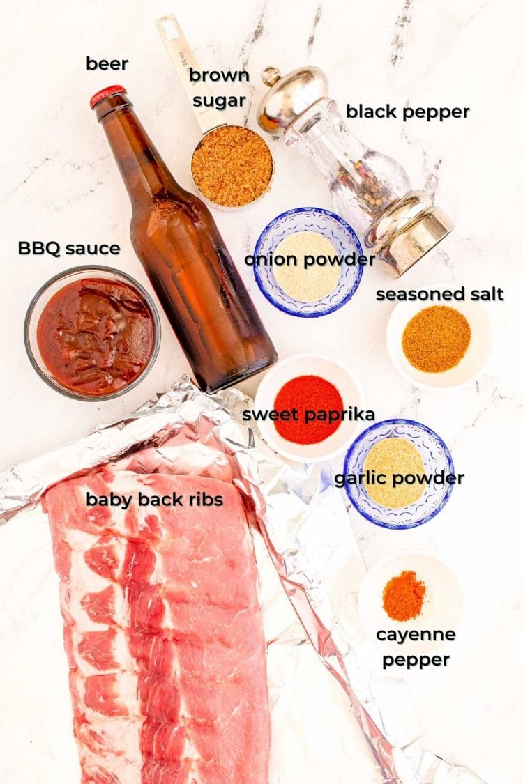 overhead photo of ingredients to make bbq baby back ribs on a marble table.