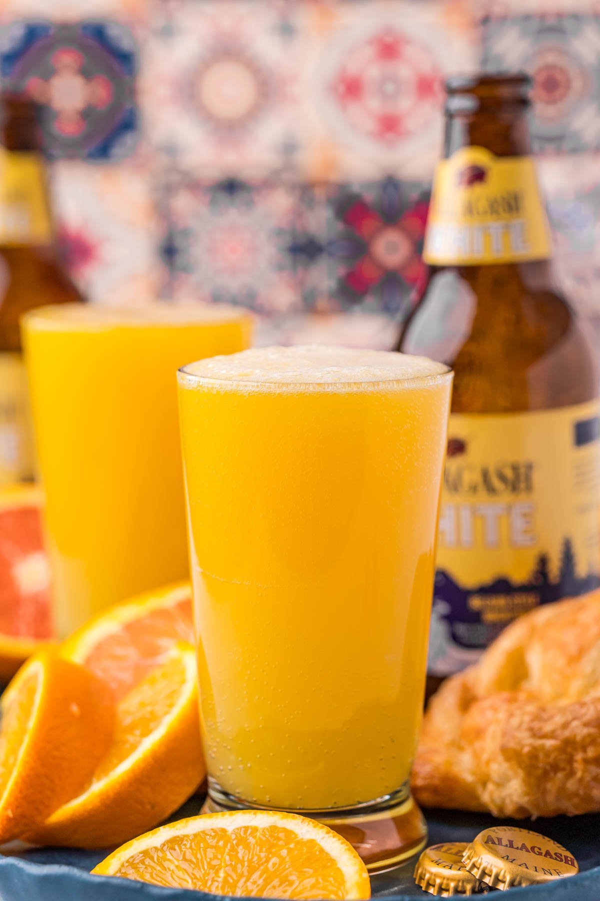 Straight on photo of a beermosa with a bottle of Allagash White in the background.