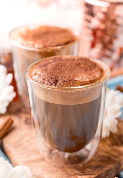 Close up photo of a double walled coffee glass filling with cafe con miel.