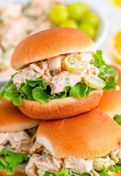 Close up photo of burger burns with chicken salad piled on a plate.