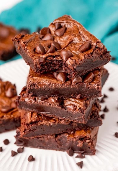 close up photo of a stack of brownies with the top one missing a bite.