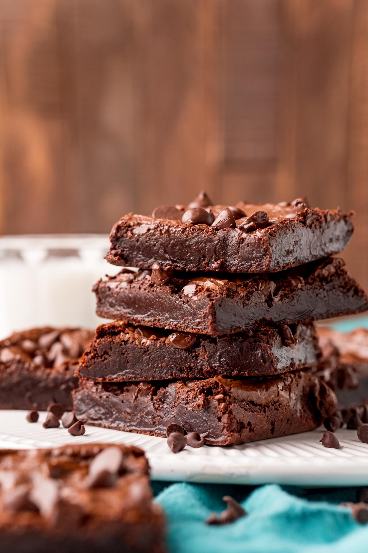 A stack of flourless chocolate brownies on a white plate.