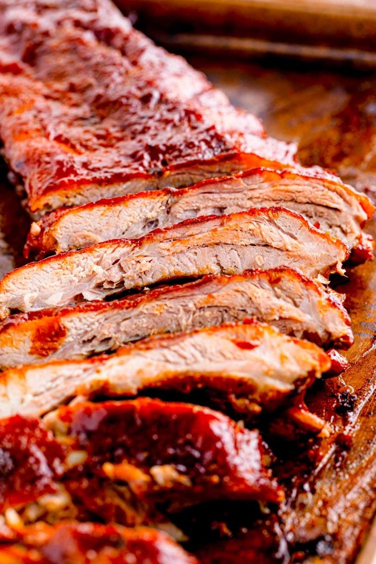 Sliced baby back ribs on a baking sheet ready to enjoy.