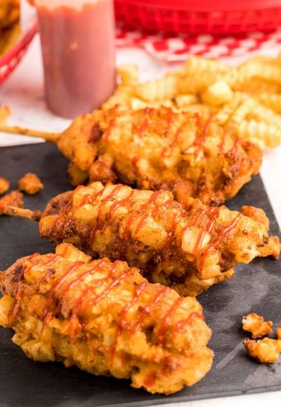 Close up photo of Korean corndogs on a slate board.