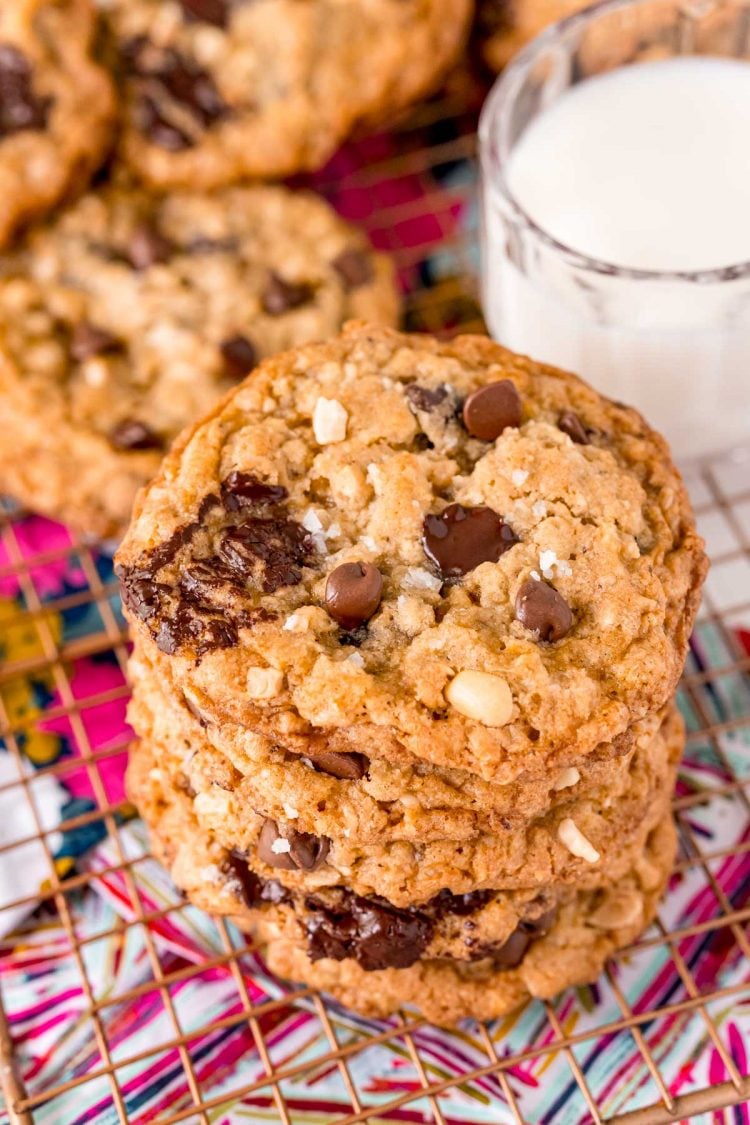 Close up photo of a stack of ranger cookies on a wire rack.