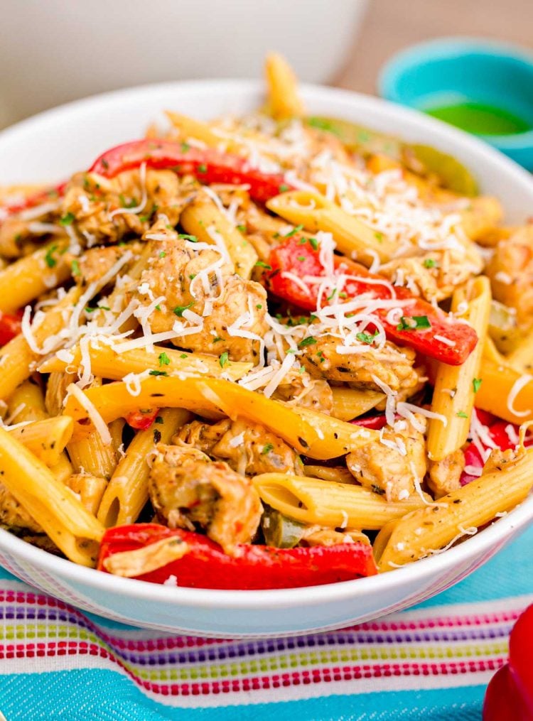 Close up photo of a bowl of Rasta Pasta on a colorful linen napkin.