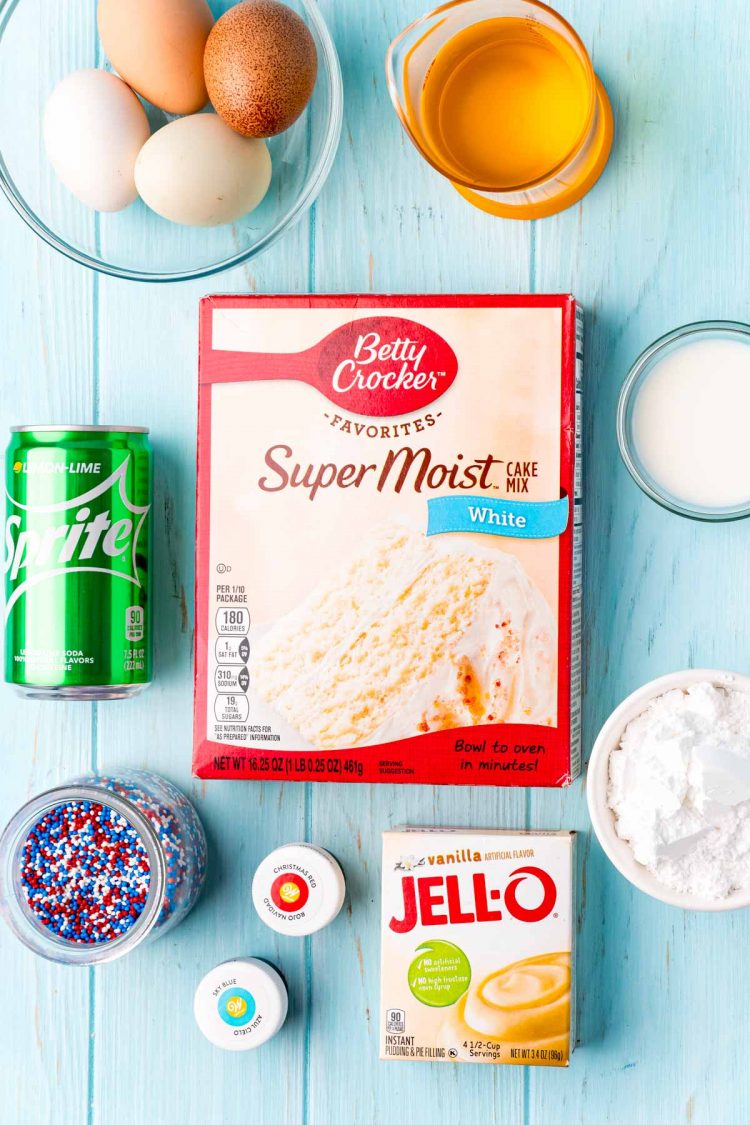 Overhead photo of ingredients used to make 4th of july sprite cake laid out on a blue wooden table.