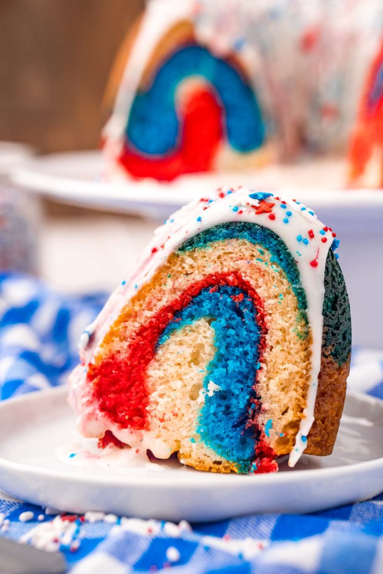 Close up photo of a slice of 4th of july red, white, and blue bundt cake.