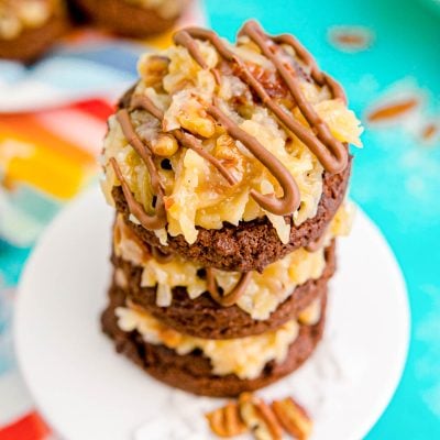 Close up photo of a stack of German Chocolate Cookies on a small white cake stand.