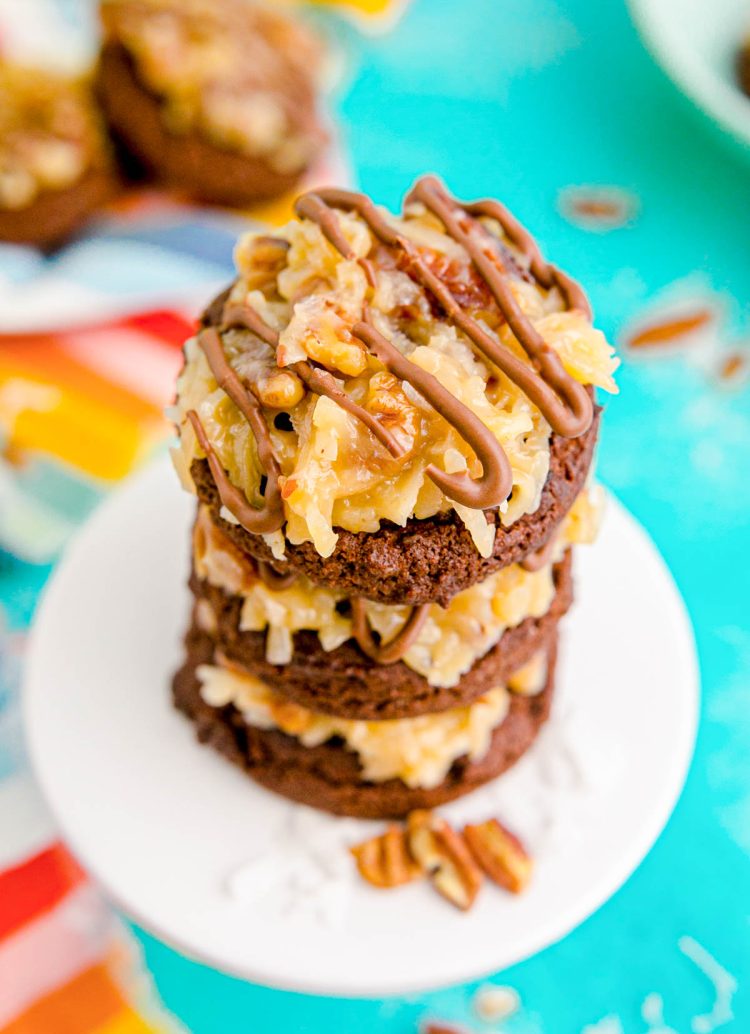 Close up photo of a stack of German Chocolate Cookies on a small white cake stand.