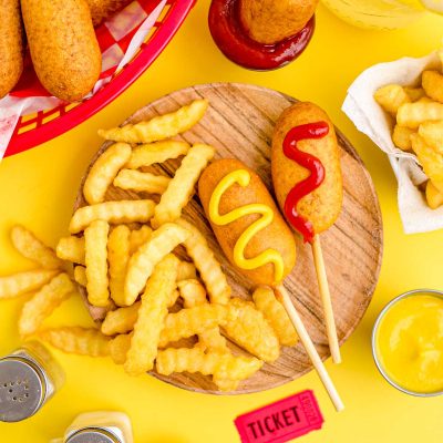 These Mini Corn Dogs take half hot dogs, roll them in a sweet, cornmeal batter, and then deep fry to golden brown perfection! Great for a weekend snack, game day appetizer, or a quick lunch your kids will love!