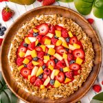 Close up photo of Nature's pizza on a wooden plate.