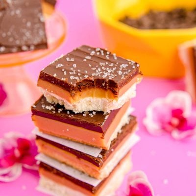 Close up photo of a stack of millionaire shortbread bars.