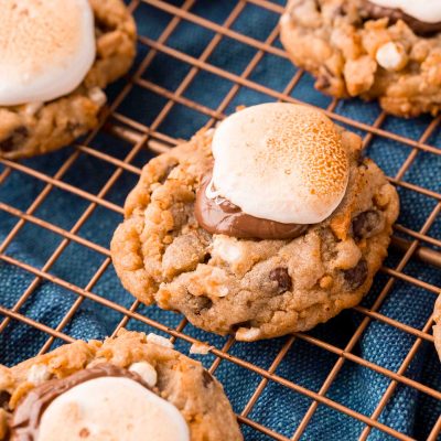 Close up photo of s'mores cookies on a copper wire rack.