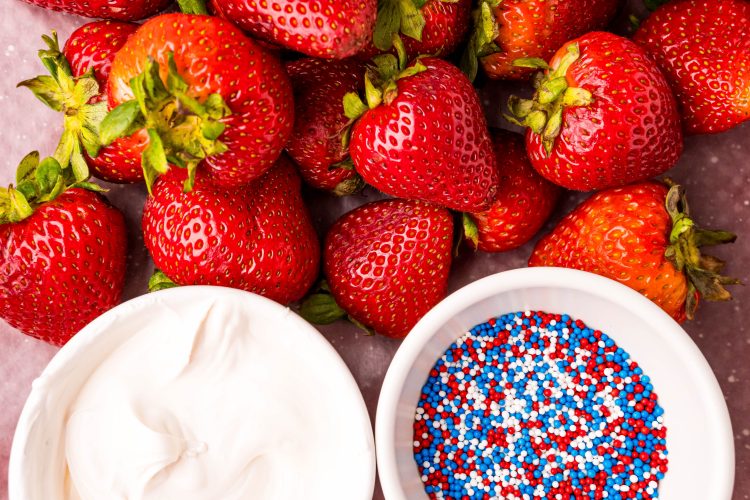 Ingredients to make 4th of july strawberries close together on a table.