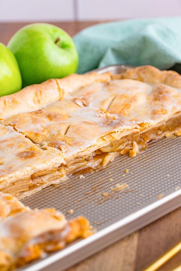 Apple slab pie on the pan with slices missing.