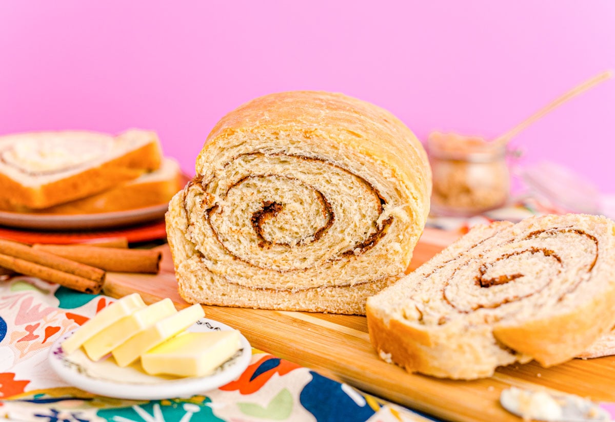 Close up photo of a loaf of cinnamon swirl bread that has been sliced into revealing the center.