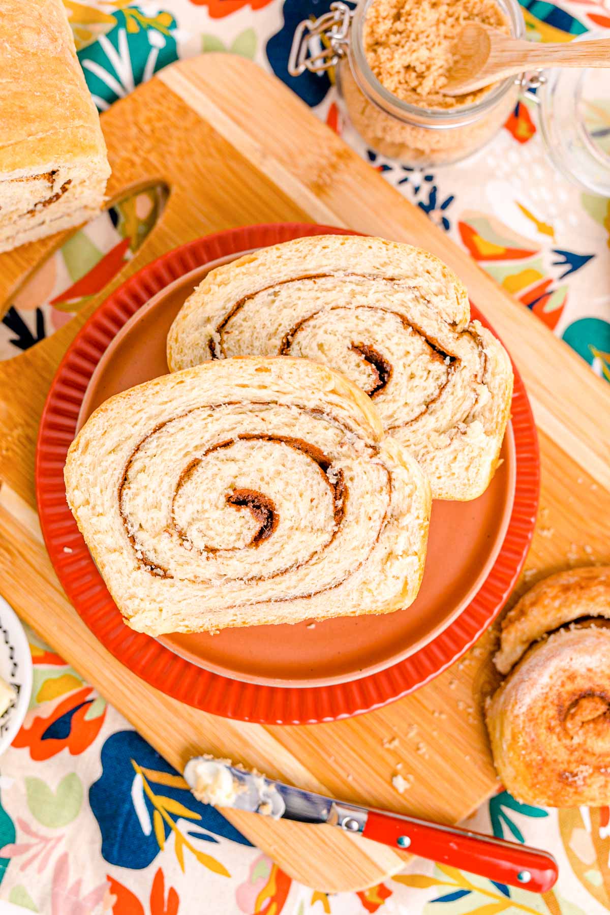 Slices of Cinnamon Swirl Bread on an orange plate.