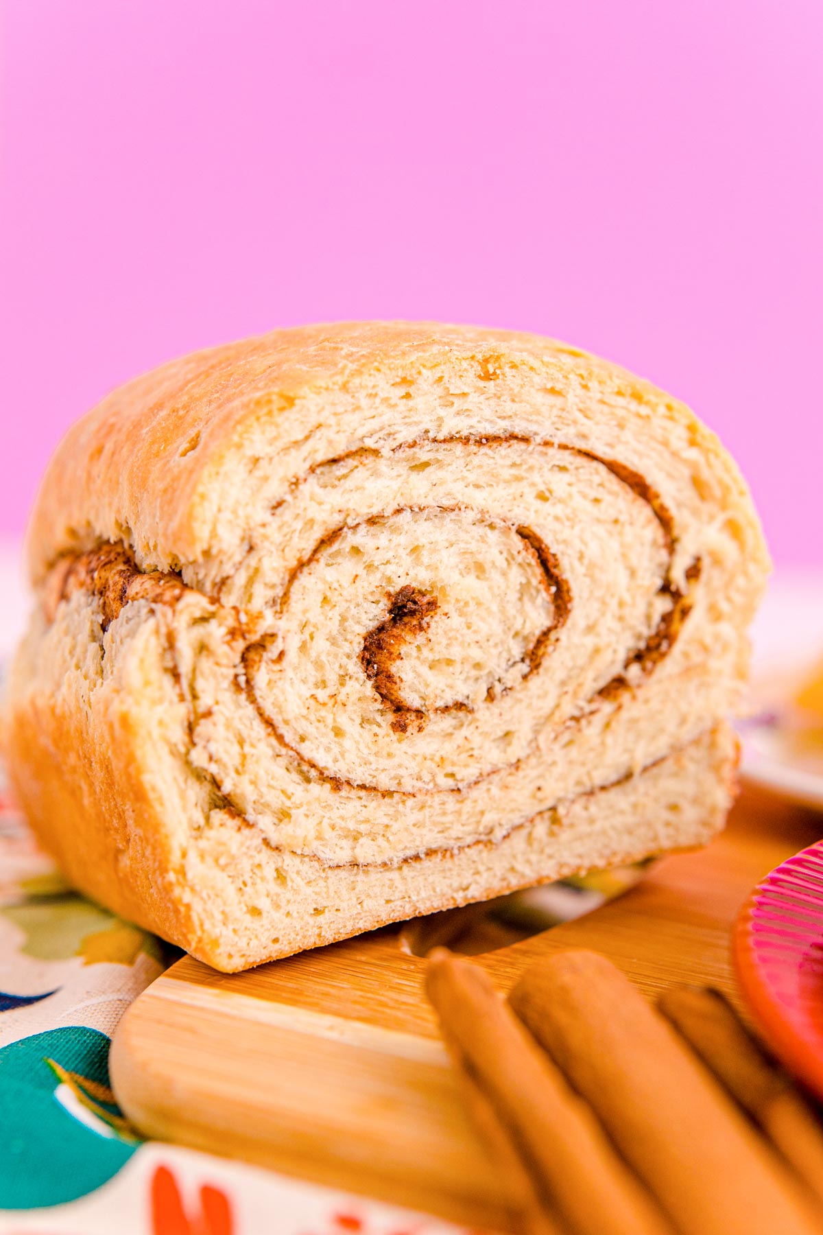 Close up photo of a loaf of cinnamon swirl bread that has been sliced into revealing the center.