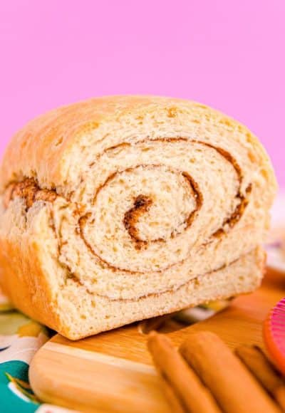 Close up photo of a loaf of cinnamon swirl bread that has been sliced into revealing the center.