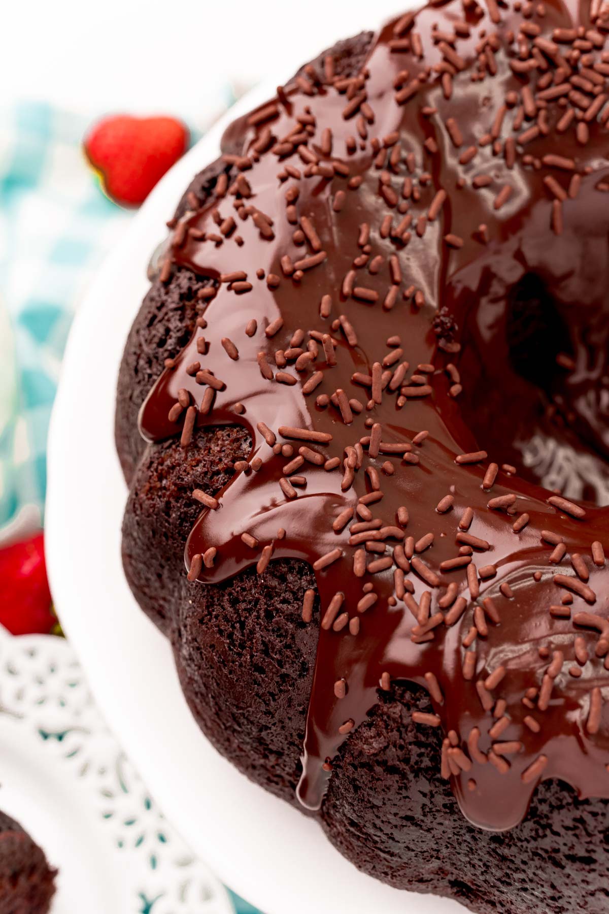 Angled photo of Devil's food cake bundt cake on a white cake stand.