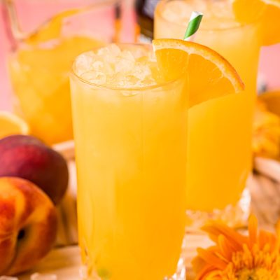 Close up photo of a fuzzy navel in a tall glass.